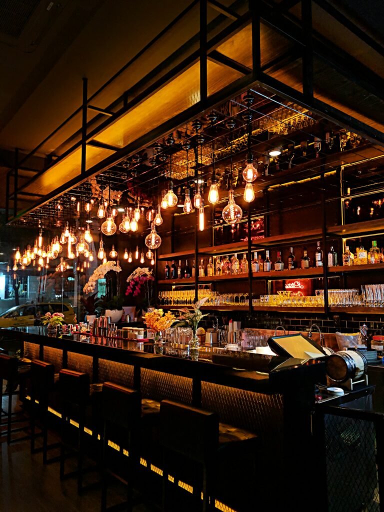 Filament bulbs glowing over a bar counter