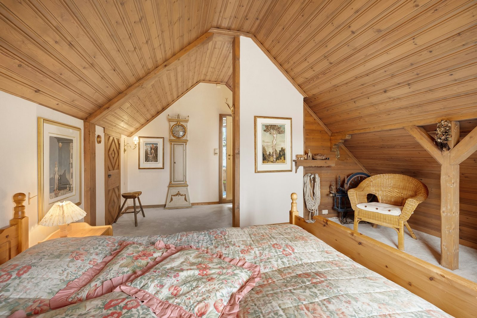 A large bed in a room with wooden walls