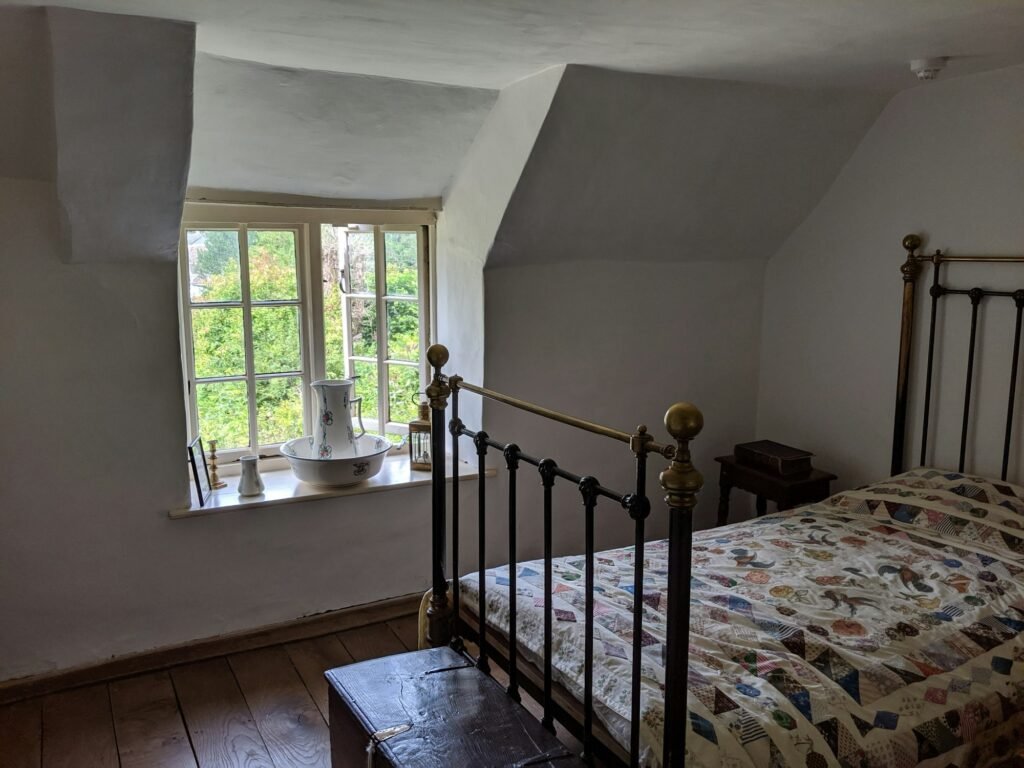 A vintage metal bed frame by a window