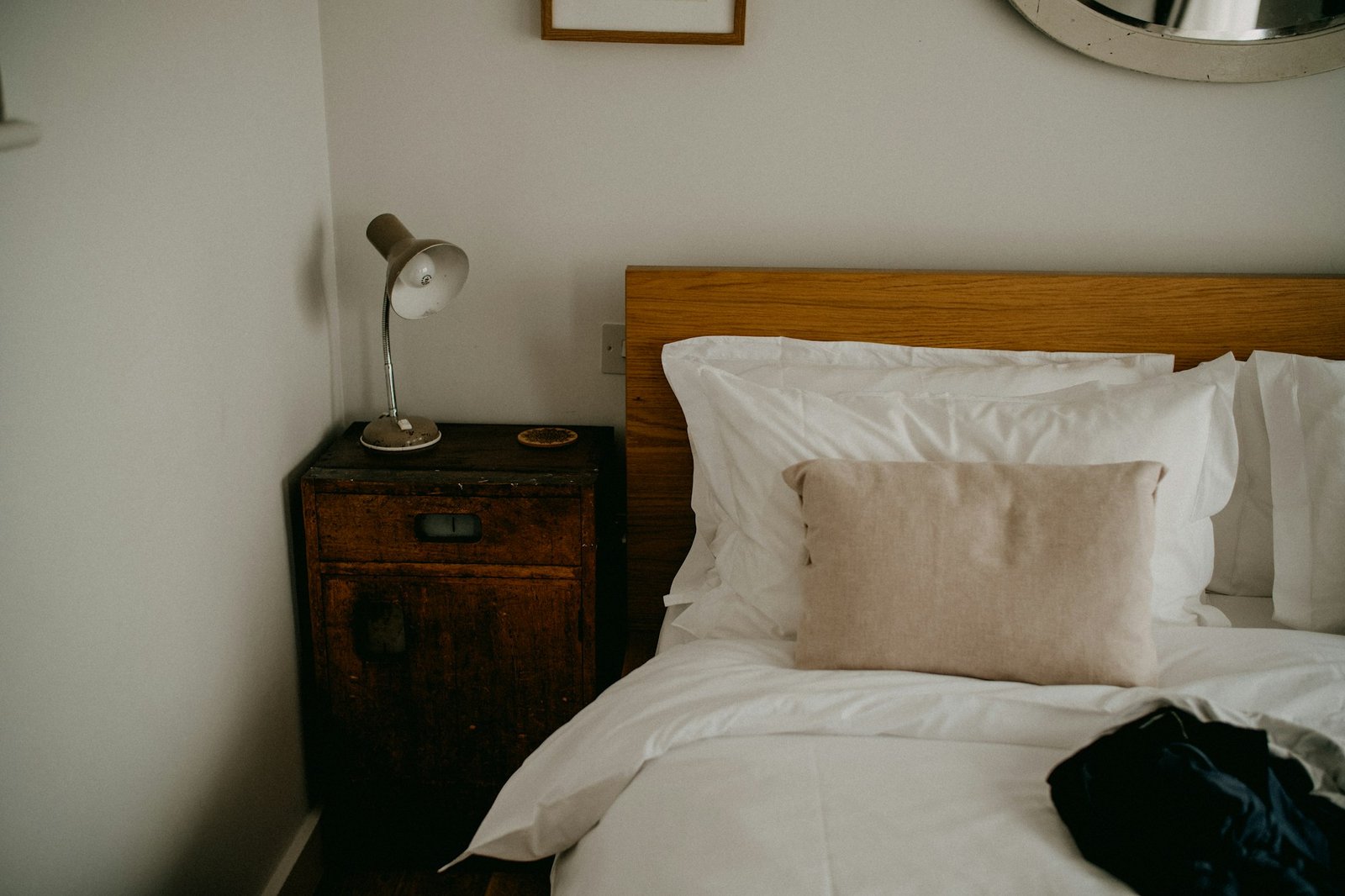 A cosy bedroom with a made bed and bedside table