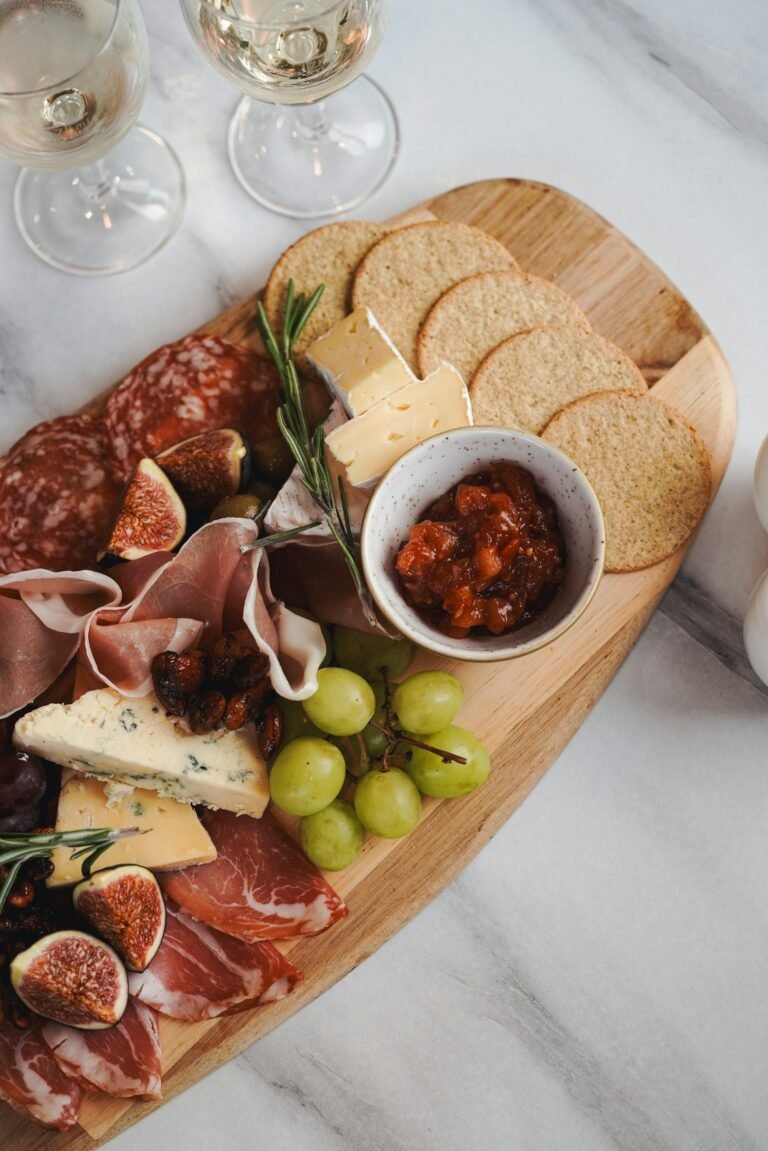 A charcuterie board with cheeses and fruit