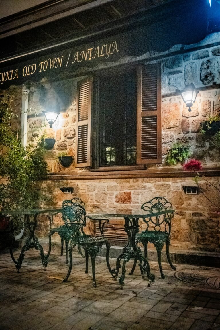 Café tables in a stone courtyard at night