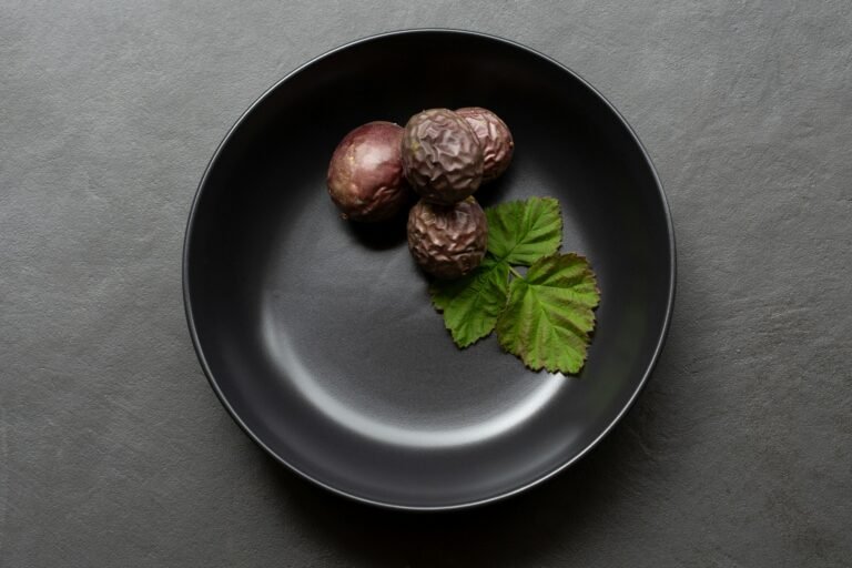 Three figs on a black plate