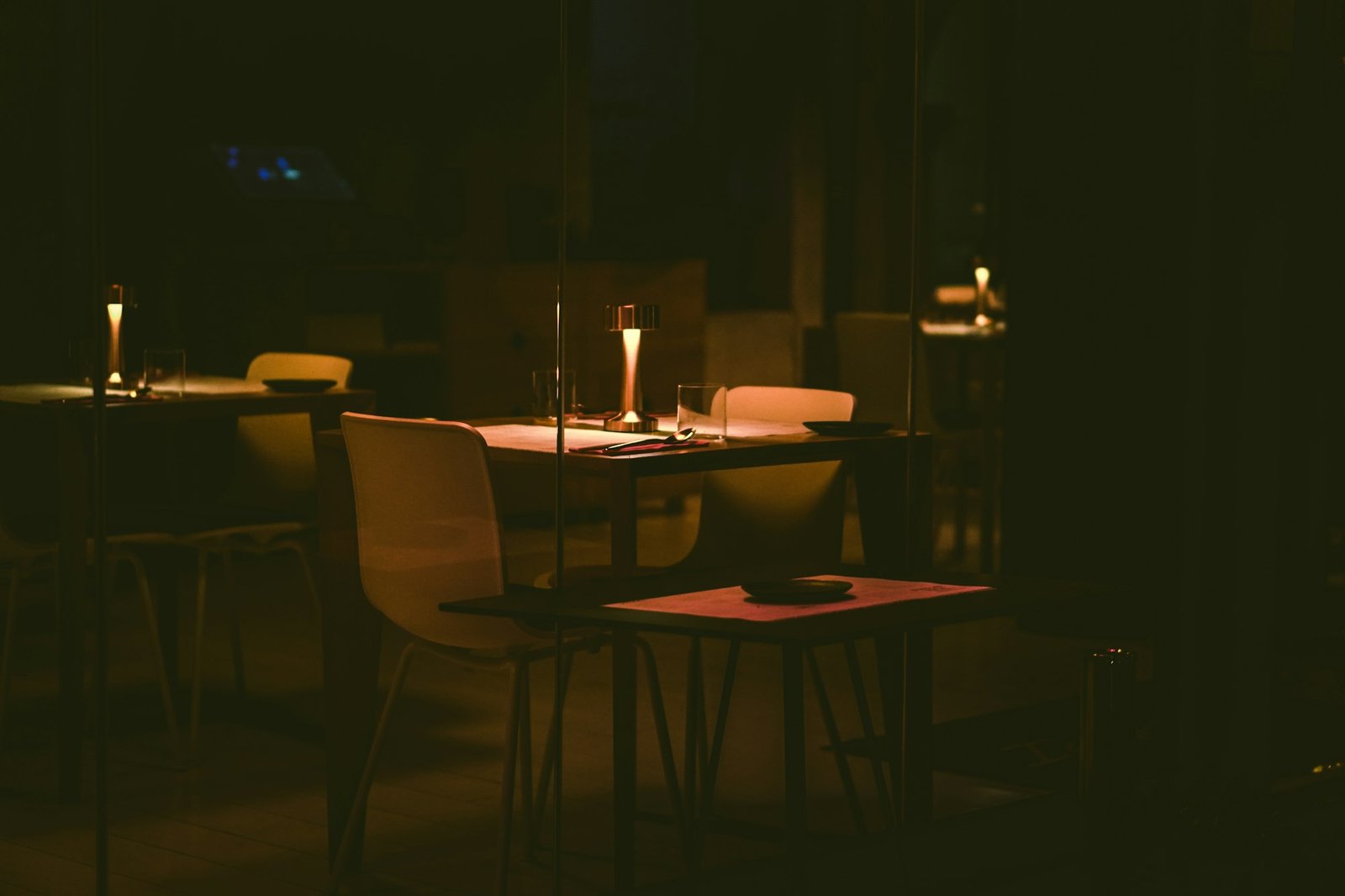Candlelit tables in a dark room