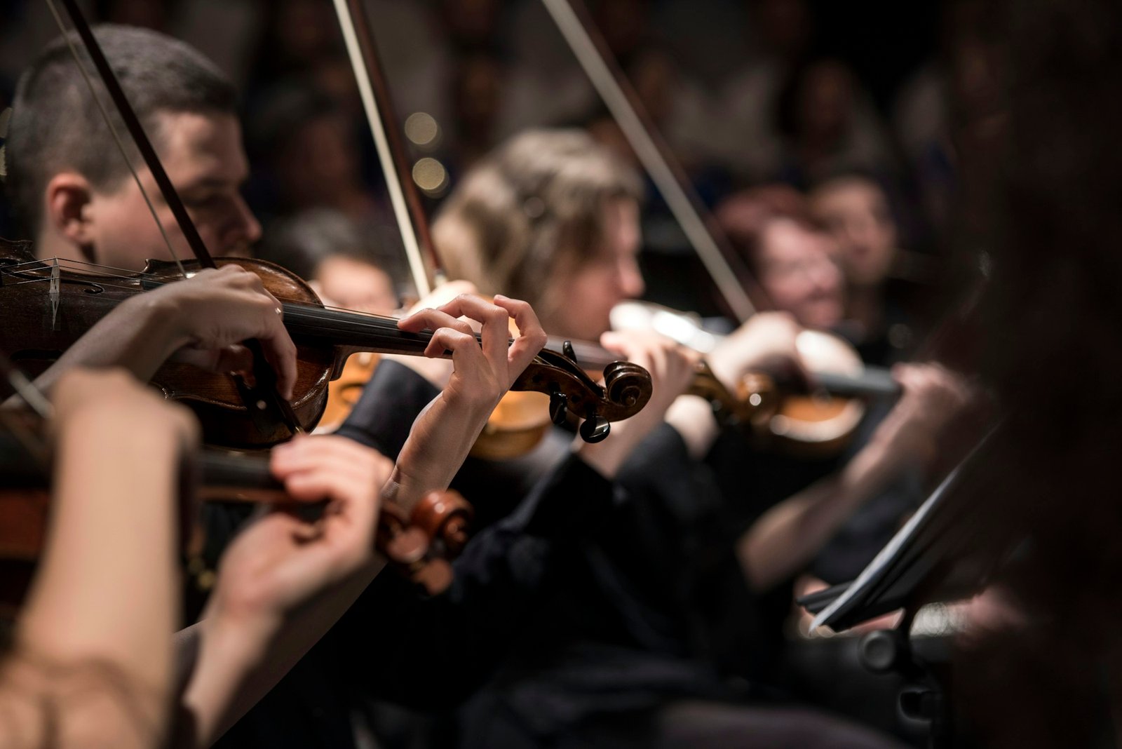 Violinists playing in a dim room